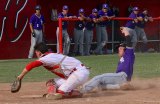 Lemoore's Jared Holaday scores in Thursday's season-ending victory over Hanford as his teammates watch from the dugout. 